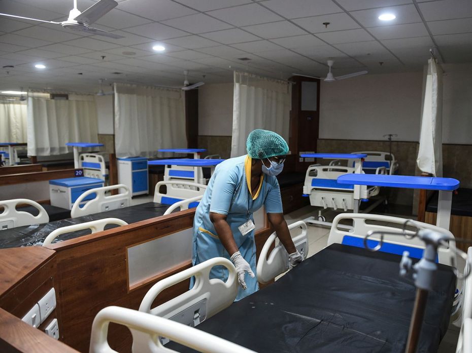 AHMEDABAD, February 4: A medical staff member arranges a bed inside an isolation ward, opened as a p