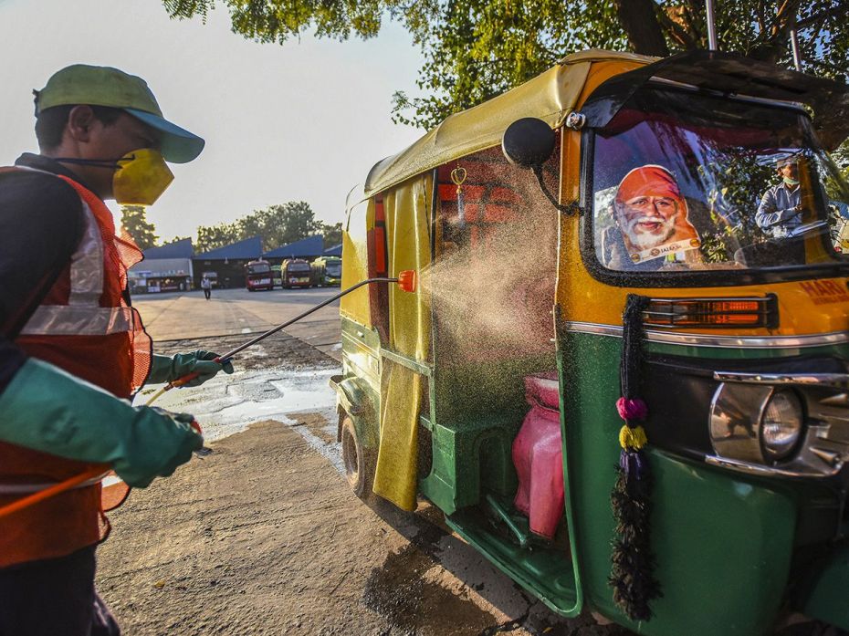 NEW DELHI, March 16: Transport Corporation (DTC) cleaning staff chemically disinfects auto rickshaws