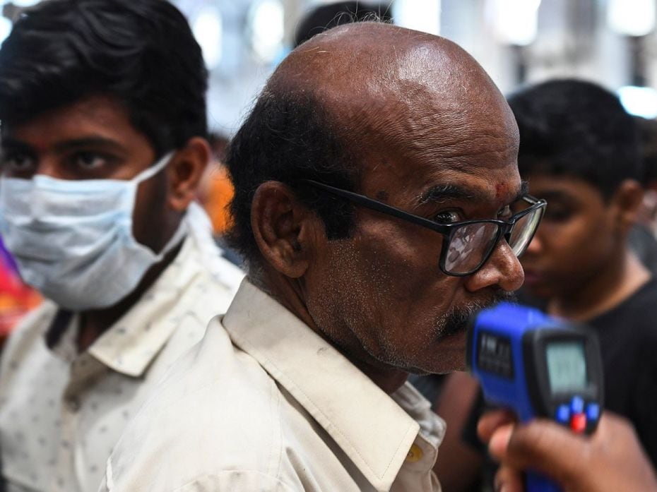 CHENNAI, March 16: A health worker checks the body temperature of a passenger amid concerns over the