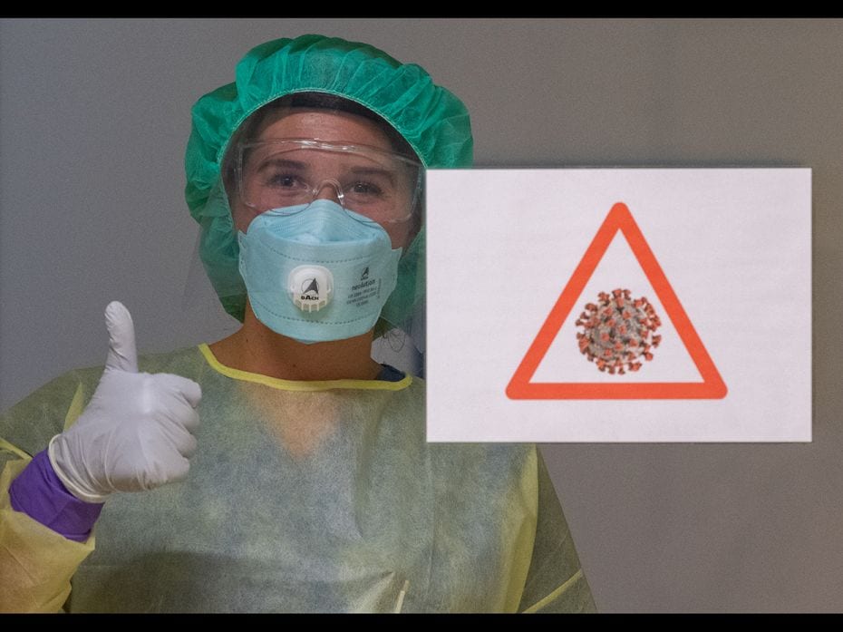 A nurse stands at the Corona Station in the Dresden Municipal Hospital in Germany, with protective g