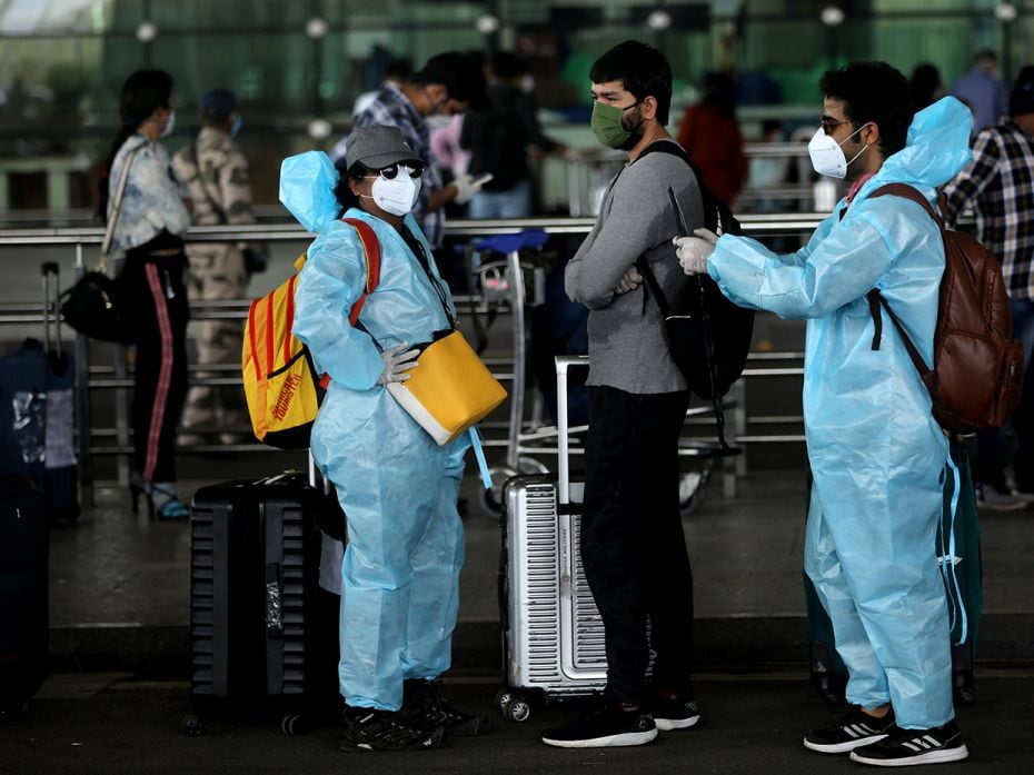 The new airport look is personal protective equipment (PPE) as these passengers show at Mumbai airpo