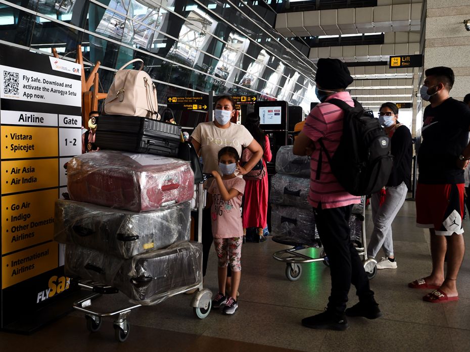 Passengers arrive at the Indira Gandhi International airport during the first day of resuming of dom