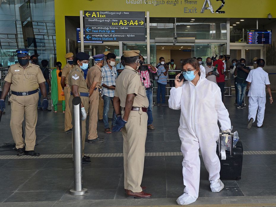 A passenger wearing a PPE suit arrives at the Kamaraj domestic airport in Chennai on May 25, 2020.