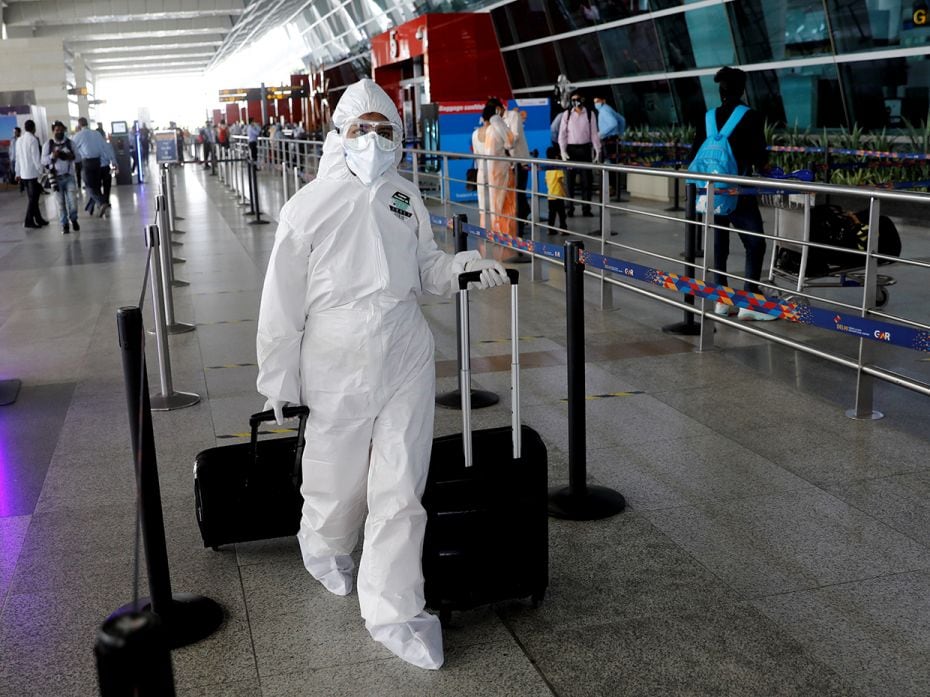 Another passenger, this time in New Delhi, shows up well-prepared for air travel in a full PPE suit