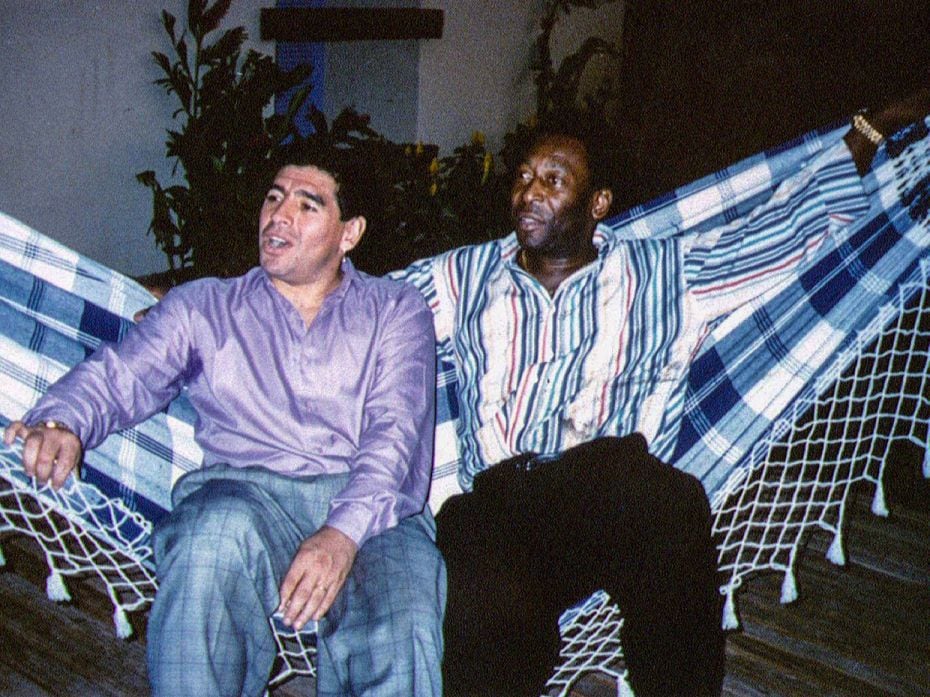 Soccer legends Diego Maradona (L) and Pele rest on a hammock during a reception in Rio de Janeiro, M