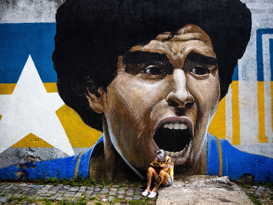 Argentina footballer of Boca Junior's women's team Yamila Rodriguez cries in front of a graffiti of 