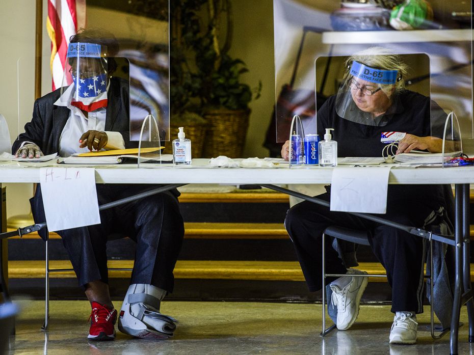 Volunteers organise ballots at their desks in North Carolina on November 3, 2020.