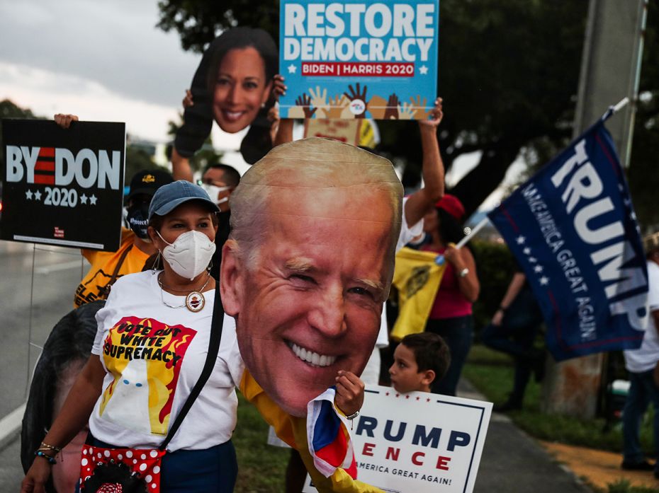 A supporter holds a cutout of Democratic presidential nominee Joe Biden outside of the Miami-Dade Co