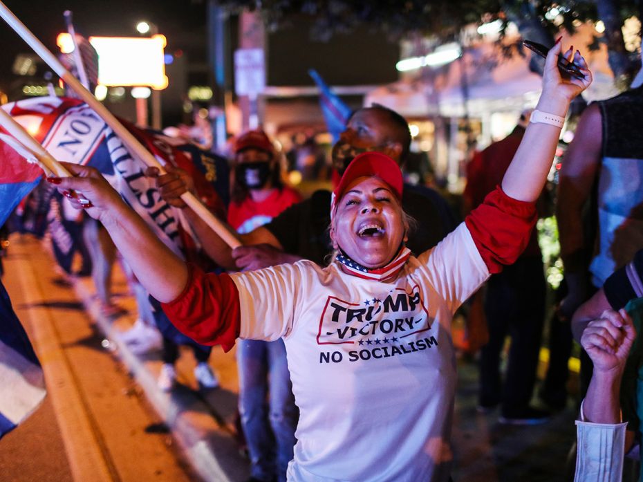 Supporters of U.S. President Donald Trump cheer outside of the Versailles restaurant as they await t