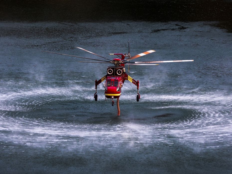 AZUSA, CA - AUGUST 15: A Sikorsky S-64 Skycrane firefighting helicopter  draws water from Morris Res