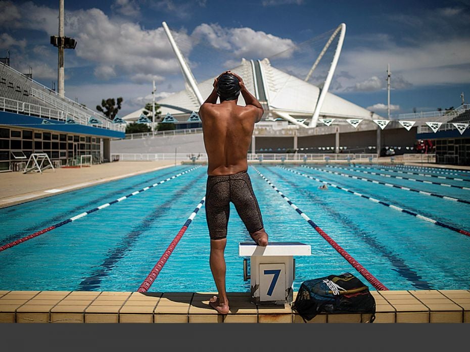 Ibrahim al-Hussein, a Syrian refugee who is an amputee swimmer, takes part in a training session at 