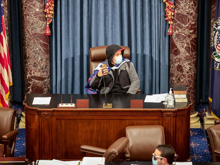 A protester sits in the Senate Chamber on January 6, 2021 in Washington, DC.