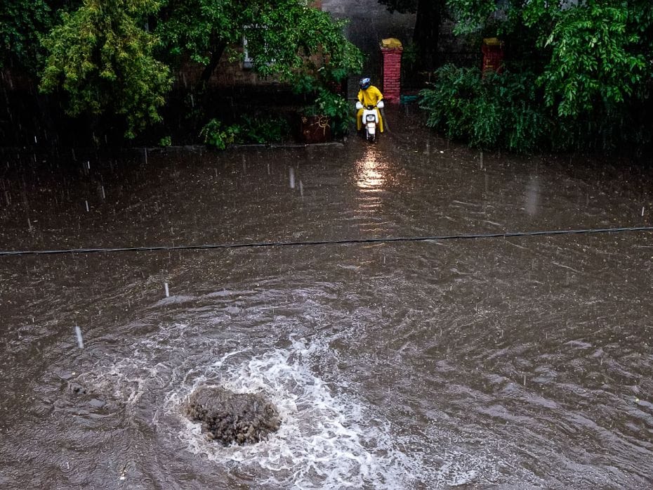 UkraineA food delivery person tries to find his way out of a flooded street during a heavy downpour 