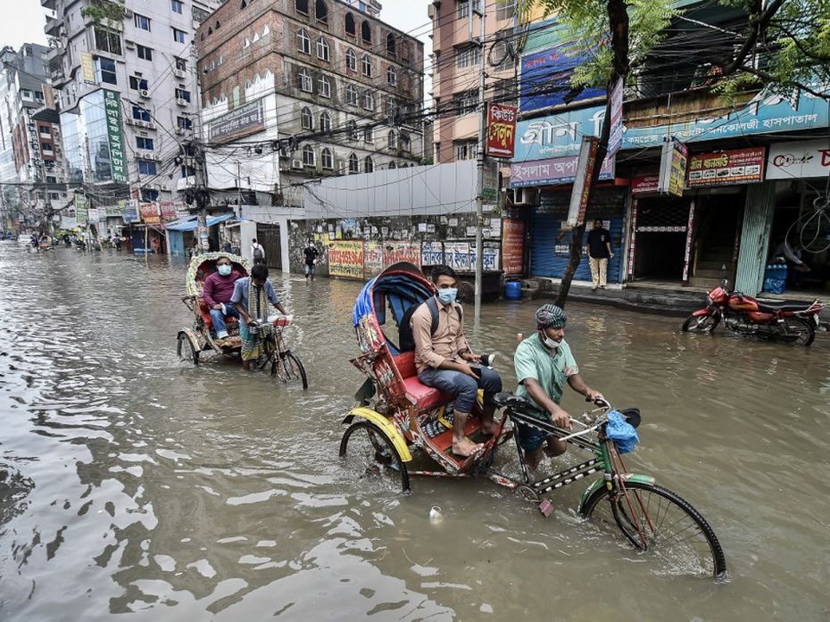 Bangladesh
Cycle rickshaw pullers wade through a waterlogged street after a heavy downpour in Dhaka