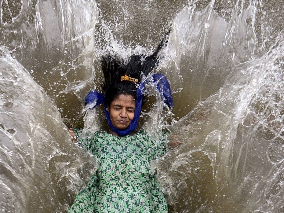 IndiaA girl plays in a waterlogged street following heavy monsoon rainfall in Mumbai. In India, mons