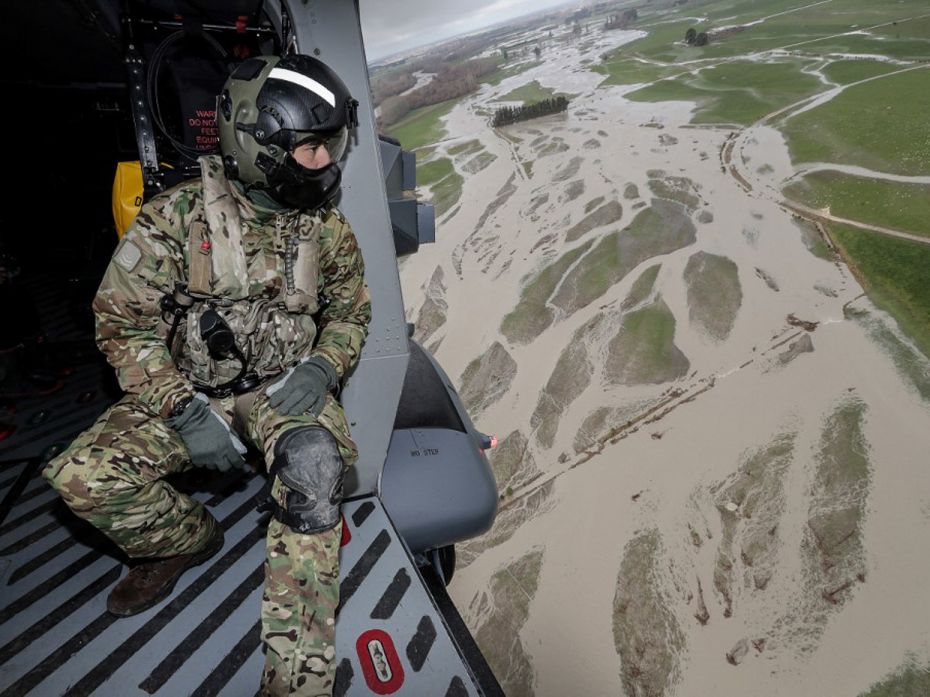 New ZealandA soldier looks out from a helicopter as they fly over the flood damage after heavy rains