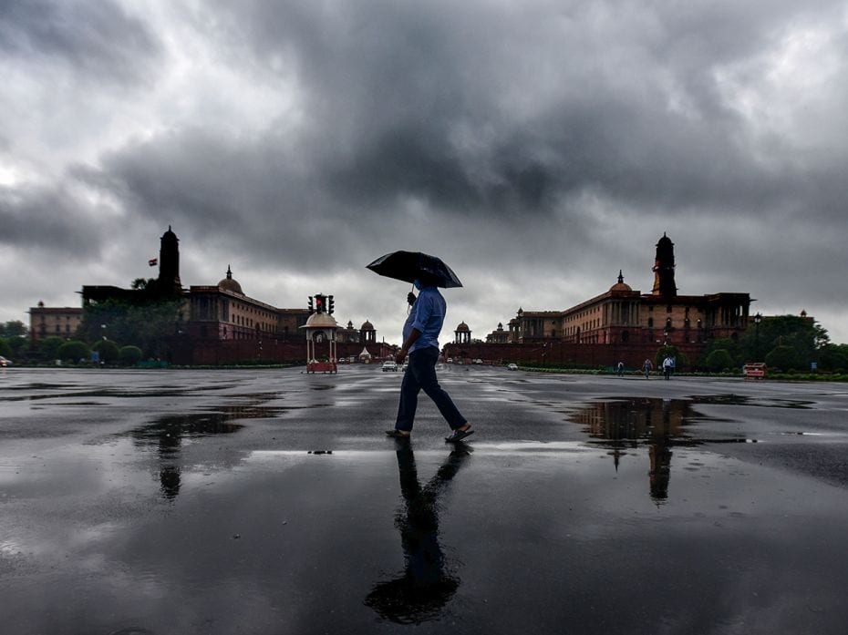 People enjoying rain shower at Vijay Chowk near North Block and South Block on July 14, 2021 in New 