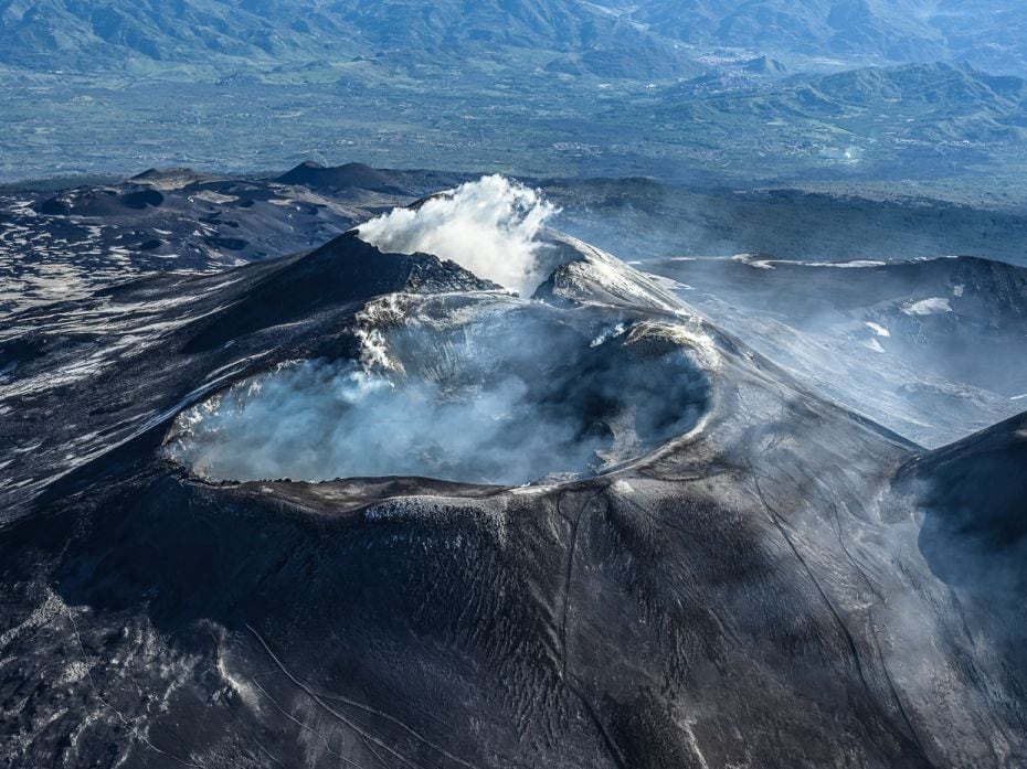 An aerial view of the summit craters of the volcano Etna. May 8, 2019. Mount Etna, towering above Ca