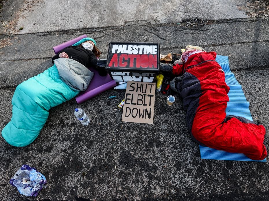 Activists lie in sleeping bags as protesters from Palestine Action and Extinction Rebellion occupy t