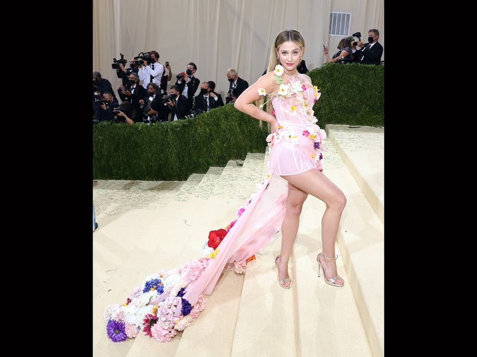 Lili Reinhart was bidding adieu to summer in thins pastel pink dress by Christian Siriano. Each flow