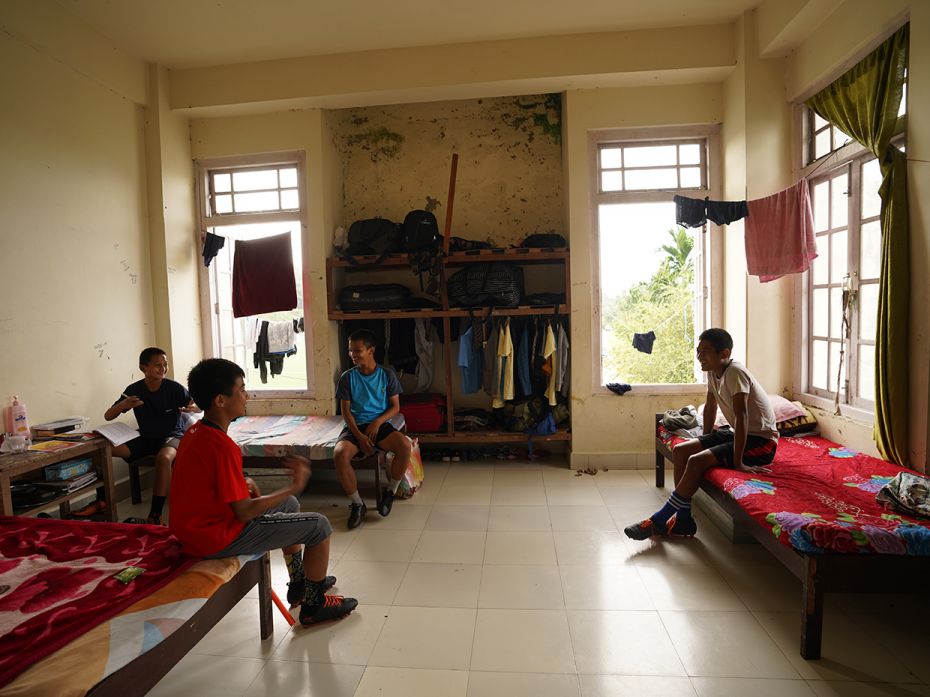 Hostellers resting in their dorm room and finishing up their homework. The programme at the Regional