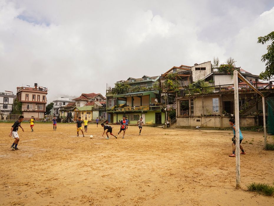 Students of government-run Chaltlang Higher Secondary School train for football during their lunch b