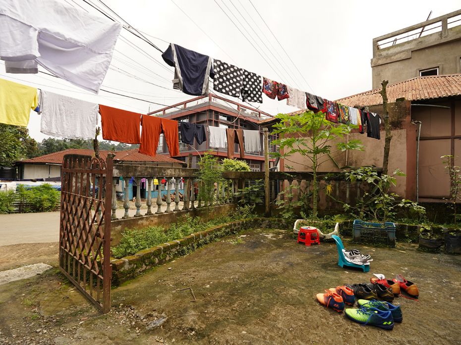 A line of football shoes left for drying on the porch of a house in Kolasib. It is never not a footb