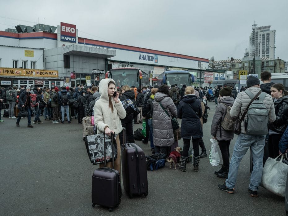 People line up at a long distance bus station in the center of Kyiv, Ukraine, on Thursday, February 