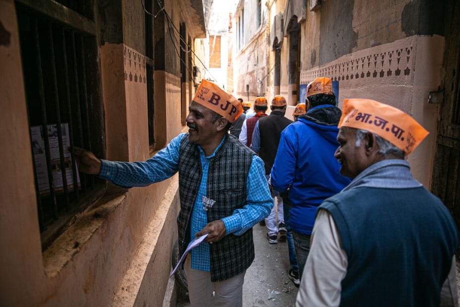 BJP workers conduct a door-to-door campaign to canvas for votes in the narrow residential alleys adj