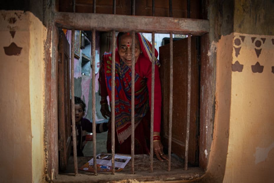 82-year-old Jatamba Devi is handed a pamphlet by the BJP workers during a door-to-door campaign. She