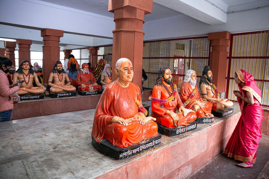 A devotee pays obeisance to a gallery of deified yogis of India at the Gorakhnath Math, founded by G