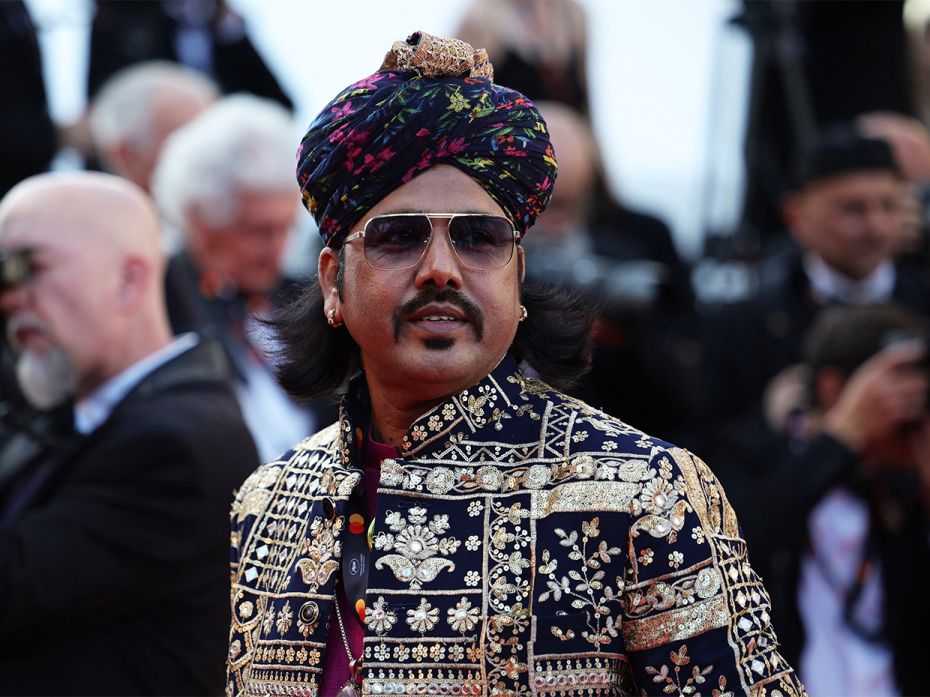 Mame Khan poses at the 75th Cannes Film Festival. He is the first Indian folk singer to walk down th