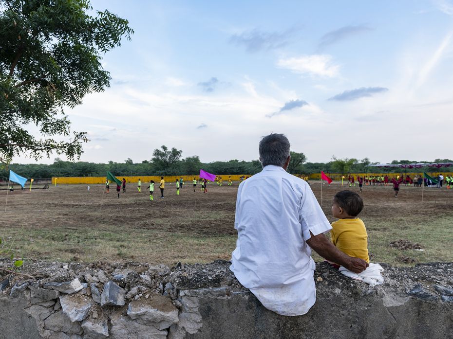 An old patriarch and his grandson from Bhavani Khera watch a football match between the teams of Han