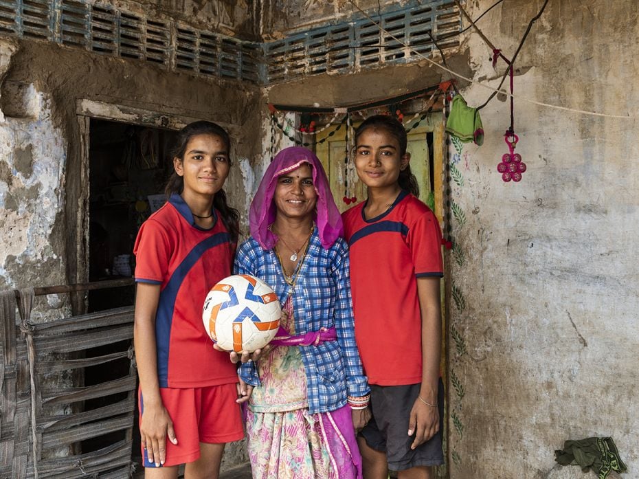 Savitri (left) and Gayatri (right) with their mother Rekha at their home in Chachiyawas village. The