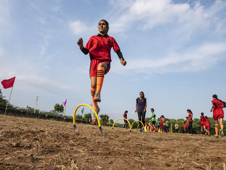 The young players participate in warm-up activities ahead of a friendly match among teams from Chach