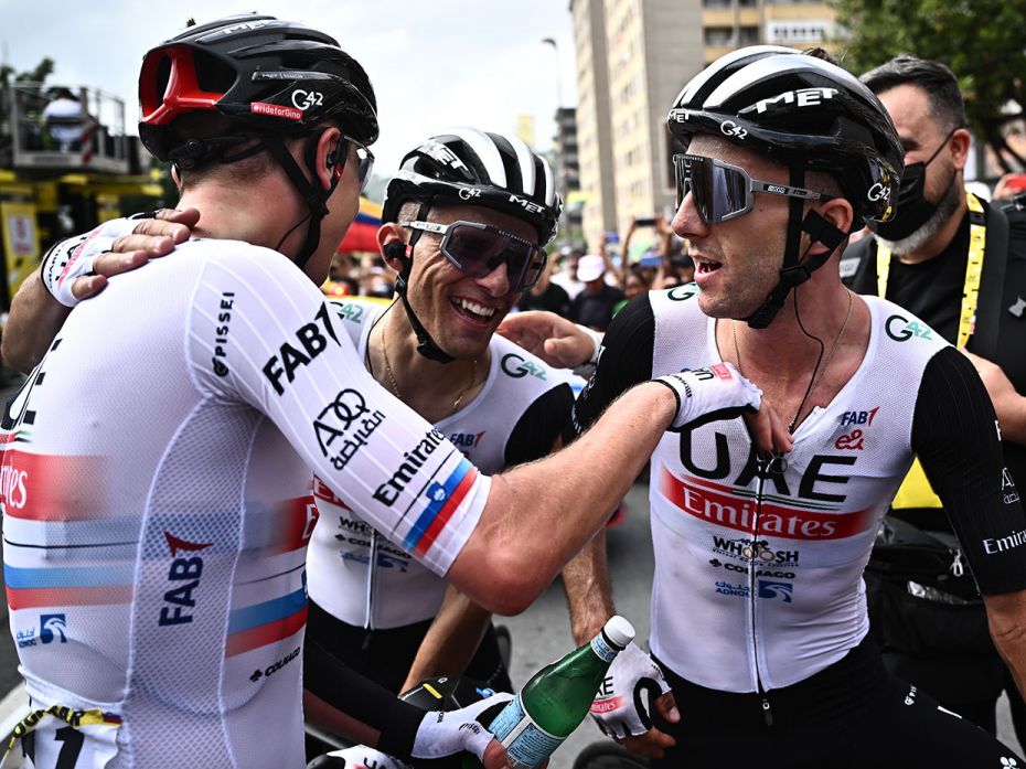 Team Emirates' rider Tadej Pogacar (L) congratulates fellow rider Adam Yates (R) after winning 1st s