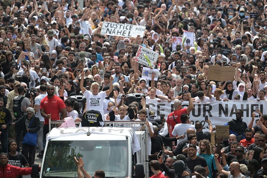 Mounia, the mother of Nahel, sits atop a truck during a commemoration march in Nanterre on June 29, 