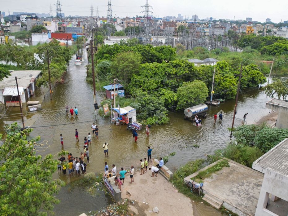 Residents shift to a safer place from the flooded Karhera area after a rise in Hindon river's water 