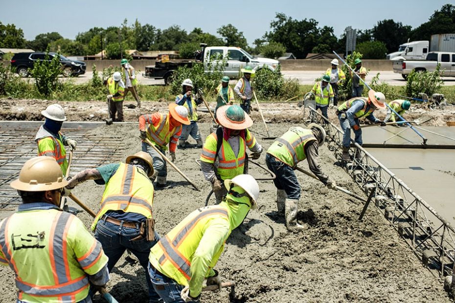 Construction crews work to repair a road damaged from the heat in Houston, Texas, on June 27, 2023.