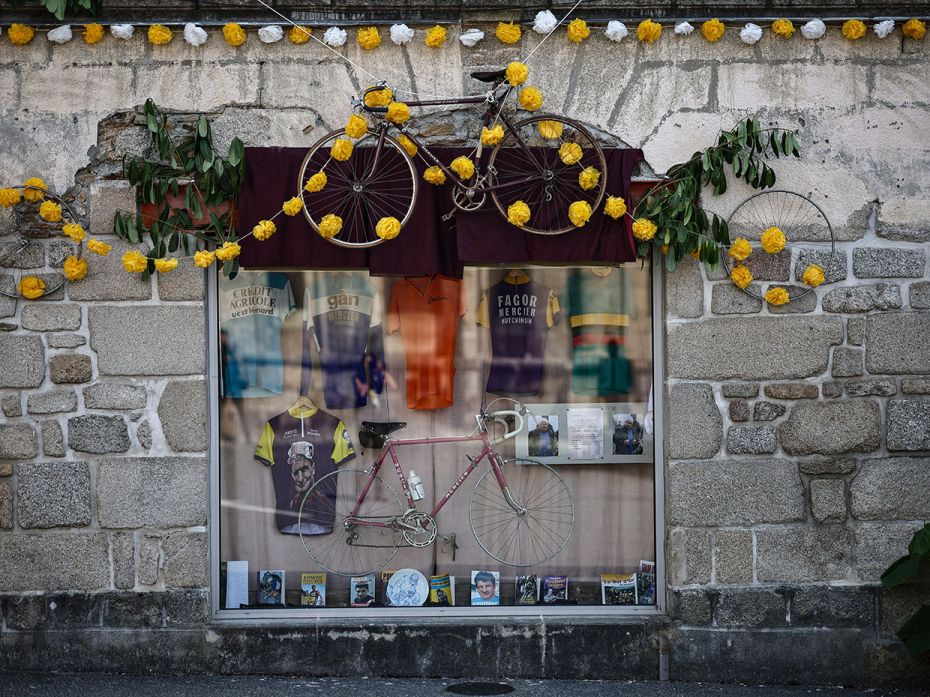 A storefront displays classic cycling paraphernalia commemorating French cycling legend Raymond Poul