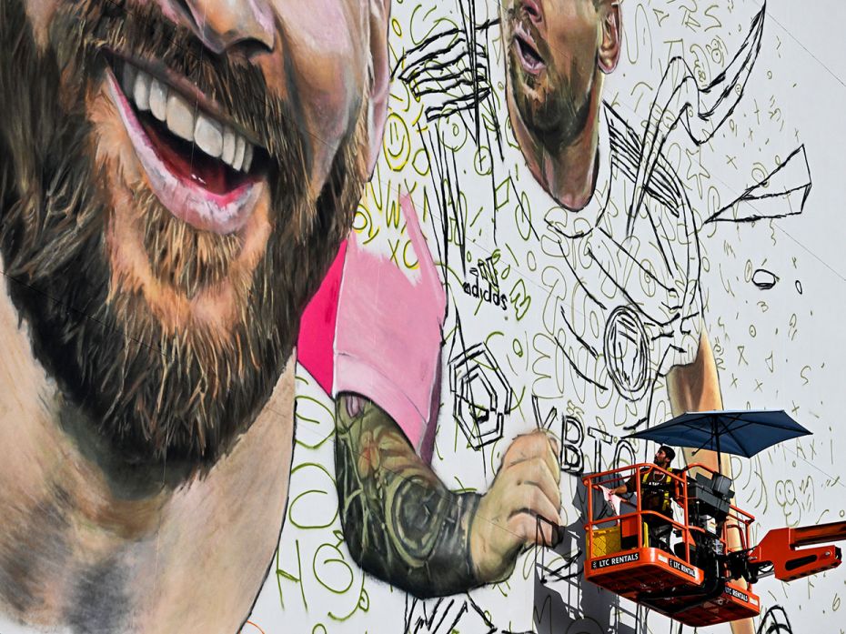 Argentine artist Maximiliano Bagnasco paints a giant mural of international soccer star Lionel Messi