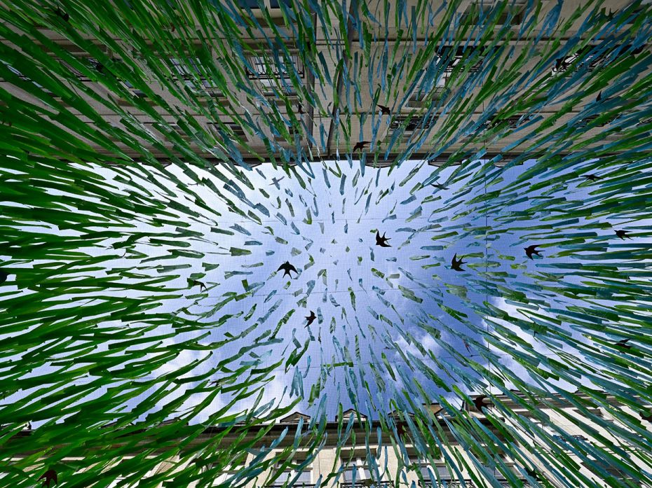 A view through heat shielding cover over a downtown shopping street in Rennes, western France, July 