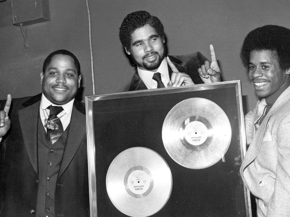 Rap pioneers the Sugar Hill Gang (L-R Big Bank Hank, Wonder Mike and Master G) receive their gold re