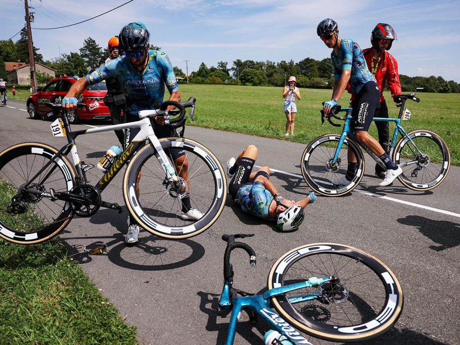 Astana Qazaqstan's rider Mark Cavendish lies on the ground after a crash during the 8th stage from L