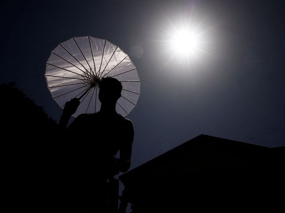 A man sells umbrellas during a scorching afternoon in Rome, Italy, July 19, 2023. 