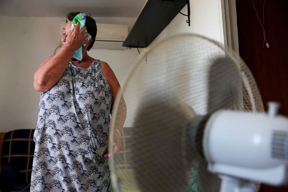 Monica Garcia, 65, wipes her sweat as residents of her neighbourhood struggle with scorching tempera