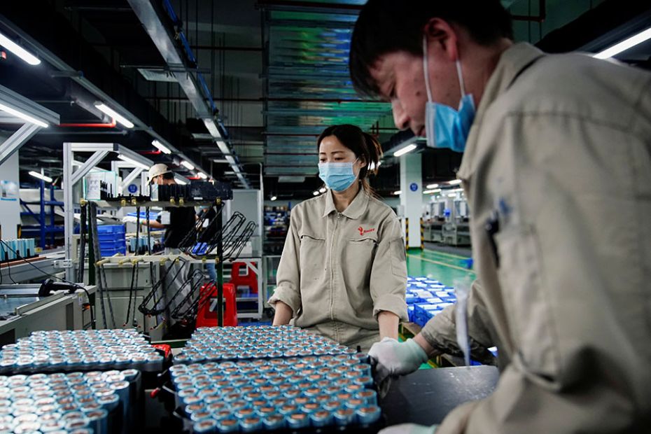 Employees work on the production line of an electric vehicle battery manufacturing unit in Hefei, An