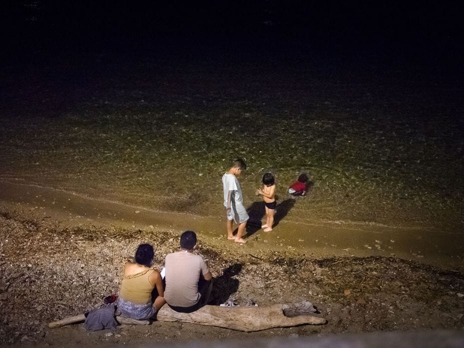 An Italian family swims at night, avoiding the scorching daylight on July 17, 2023, in Livorno, Ital