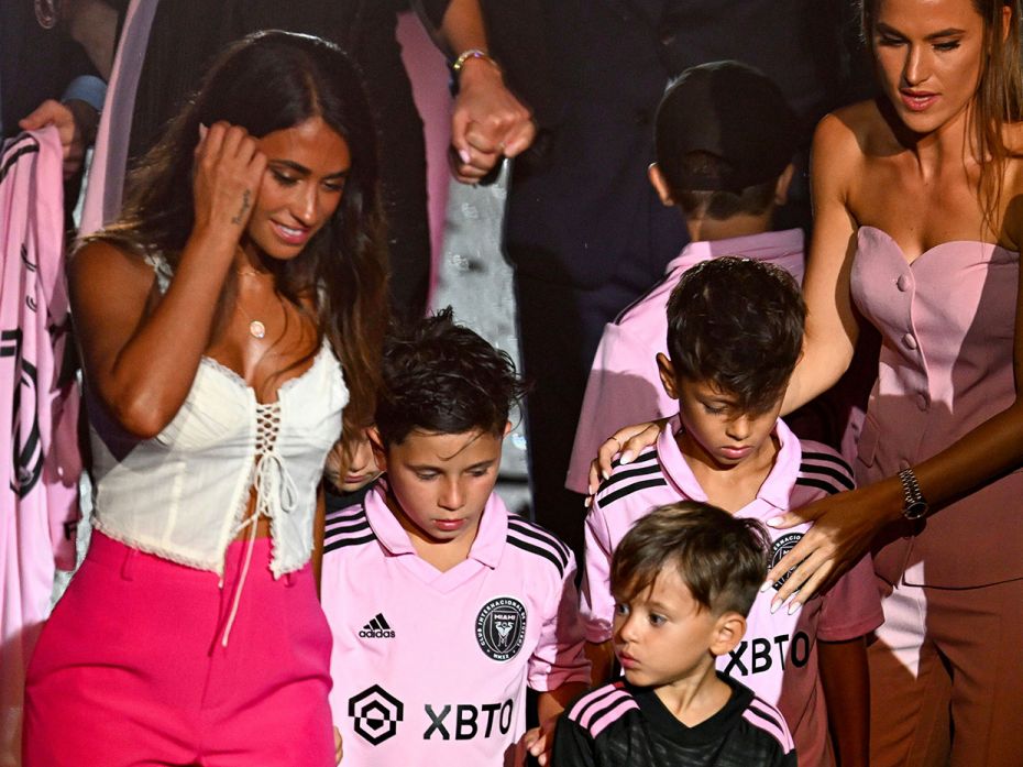 Antonela Roccuzzo (L), with children Thiago, Mateo and Ciro, attends her husband Messi's unveiling a