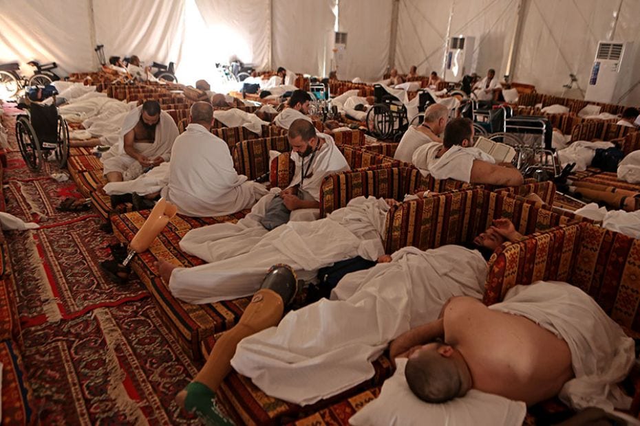 Hordes of Syrian amputees rest inside their tent near Mount Arafat during the Hajj pilgrimage on Jun